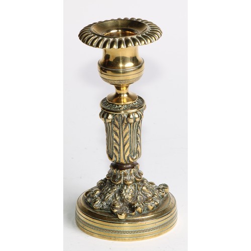 2092 - A pair of Regency bronze candlesticks, campana sconces with fluted nozzles, acanthus cast pillars, c... 