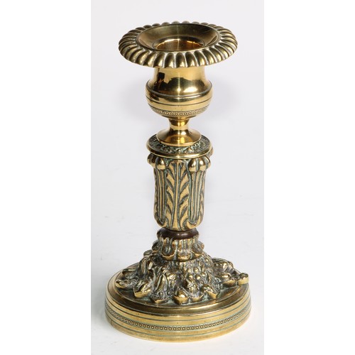 2092 - A pair of Regency bronze candlesticks, campana sconces with fluted nozzles, acanthus cast pillars, c... 