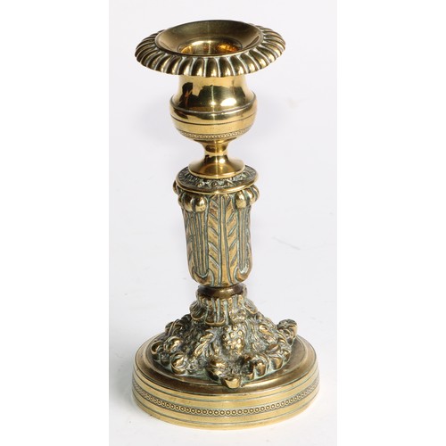 2092 - A pair of Regency bronze candlesticks, campana sconces with fluted nozzles, acanthus cast pillars, c... 