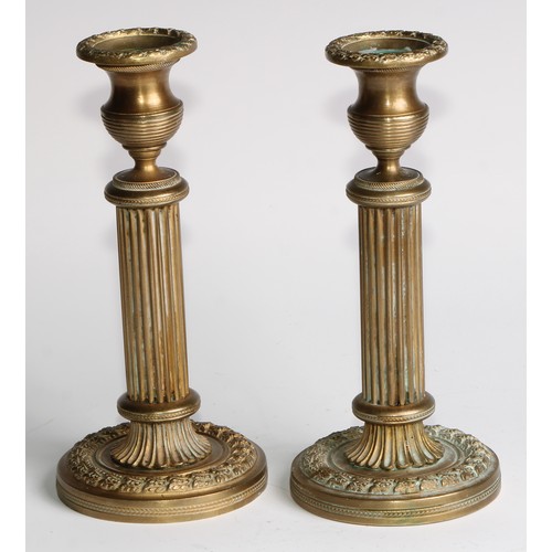 1817 - A pair of 19th century gilt bronze candlesticks, campana sconces, fluted pillars, acanthus borders, ... 