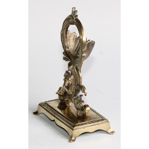 1555 - A 19th century brass pocket watch stand, cast in the Rococo taste with a figure reading, 17cm high, ... 