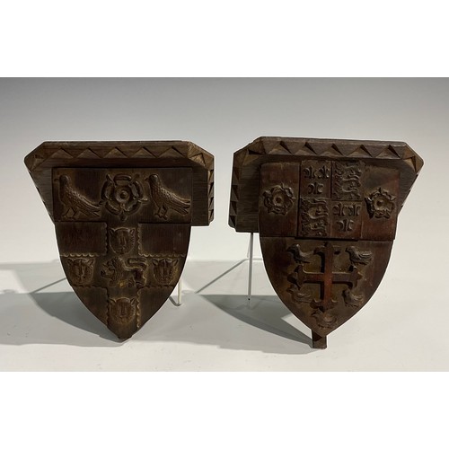 1820 - A pair of 19th century Gothic Revival oak armorial wall brackets, carved with the coats of arms of C... 