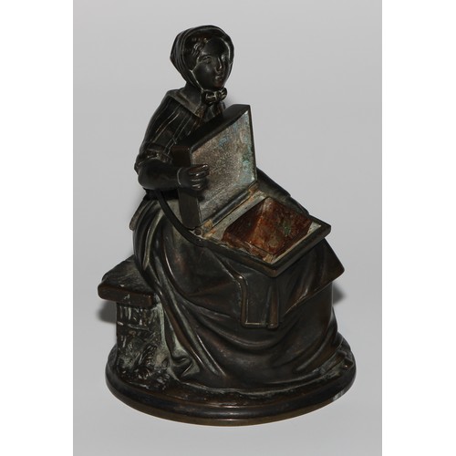 1559 - A 19th century dark patinated bronze novelty so-to-bed or table vesta, as a match girl, the box on h... 