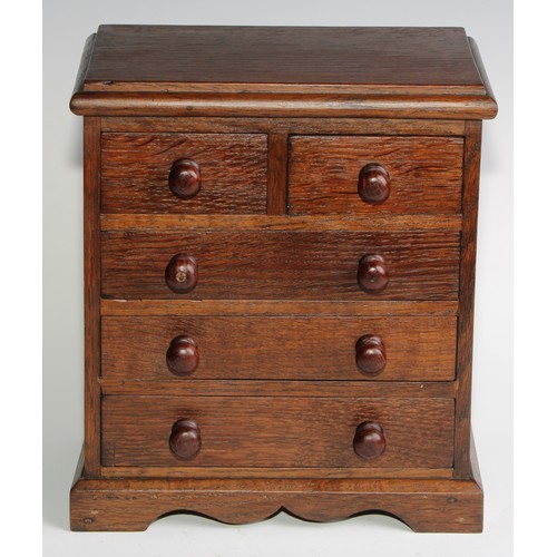 1926 - An Edwardian oak miniature chest, rectangular top above two short and three long graduated drawers, ... 