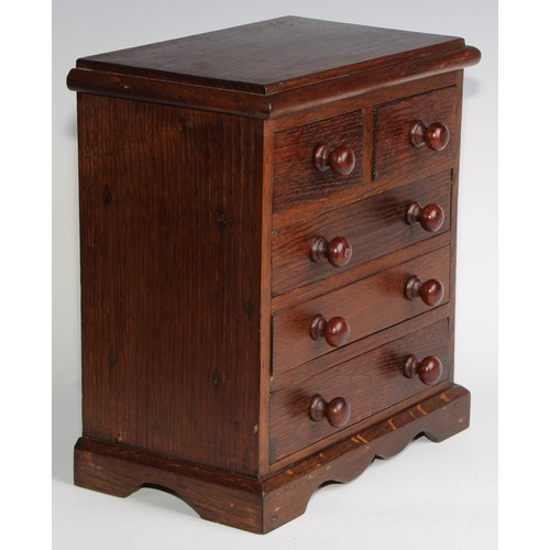 1926 - An Edwardian oak miniature chest, rectangular top above two short and three long graduated drawers, ... 