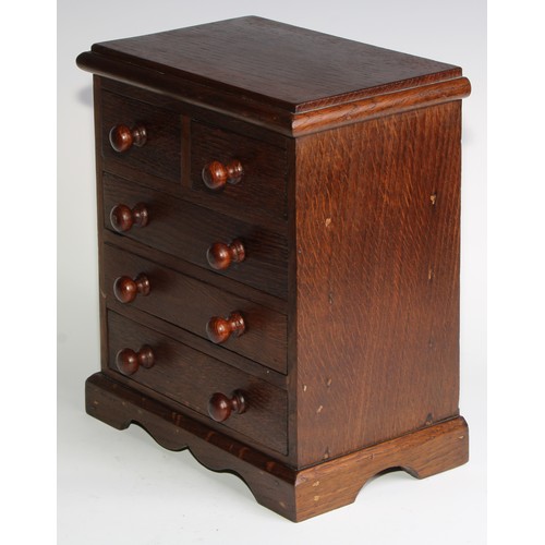 1926 - An Edwardian oak miniature chest, rectangular top above two short and three long graduated drawers, ... 