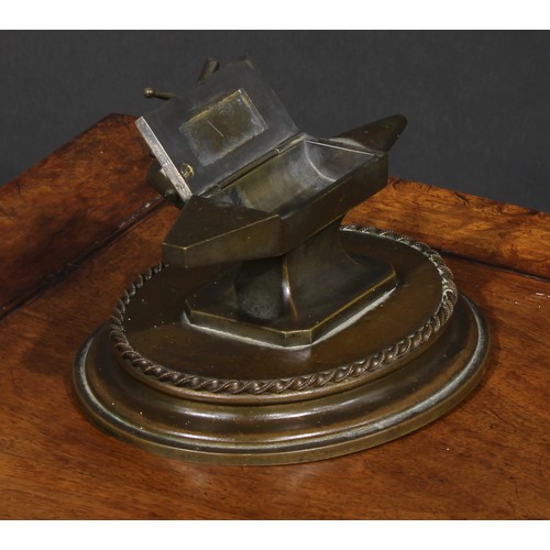 1556 - A 19th century bronze novelty table vesta, as a blacksmith's anvil, the hinged cover with hammer and... 