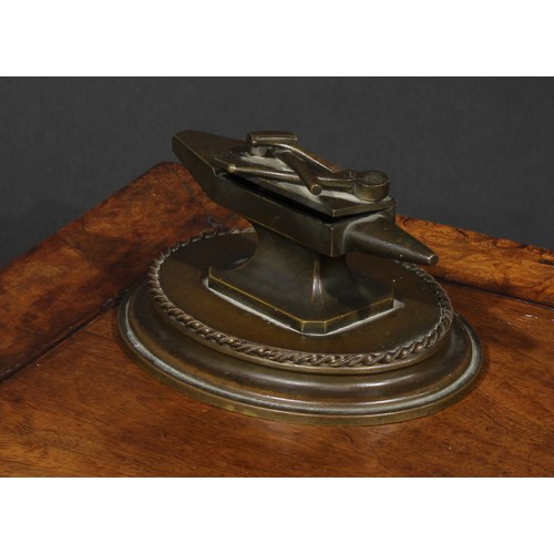 1556 - A 19th century bronze novelty table vesta, as a blacksmith's anvil, the hinged cover with hammer and... 