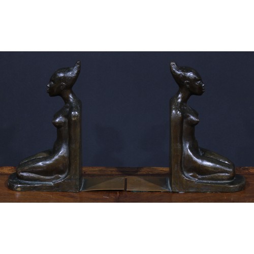 1823 - A pair of Art Deco brown patinated bronze bookends, probably Austrian, each cast as a kneeling exoti... 