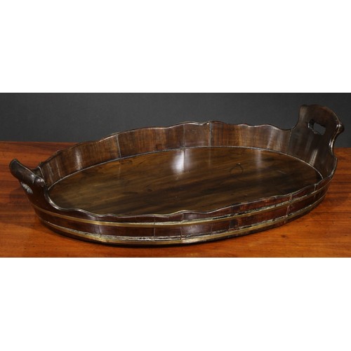 1554 - A 19th century brass bound coopered mahogany two-handled tray, wavy gallery with pierced carrying ha... 