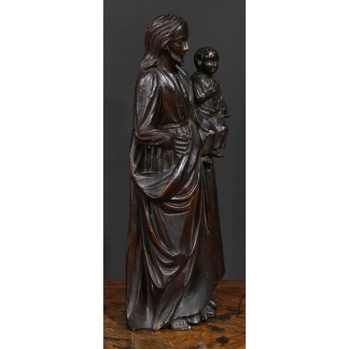 2631 - An 18th century Continental softwood figure, carved as Christ holding an infant, 50cm high, c.1700-1... 