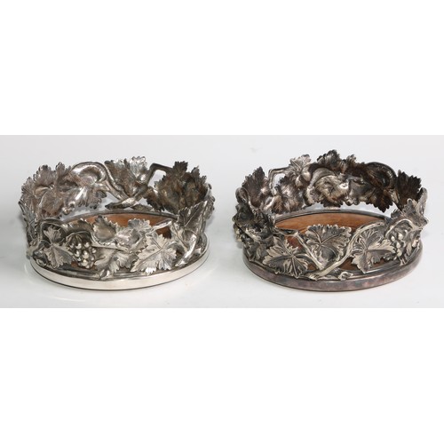 826 - A pair of Victorian electroplated wine coasters, pierced and in bold relief with fruiting vine, drau... 