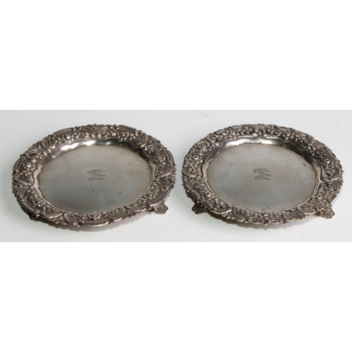 1032 - A pair of Portuguese silver shaped circular card waiters of salvers, each chased with a band of flow... 