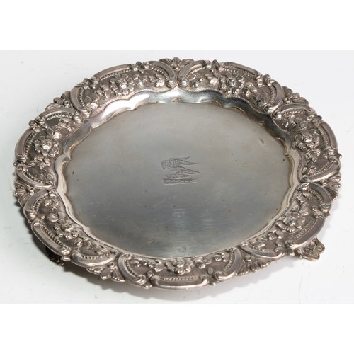 1032 - A pair of Portuguese silver shaped circular card waiters of salvers, each chased with a band of flow... 