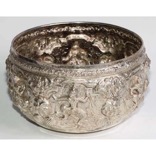 859 - A Burmese silver circular bowl, repousse chased with figures, deities and lotus, 21cm diam, c.1880, ... 