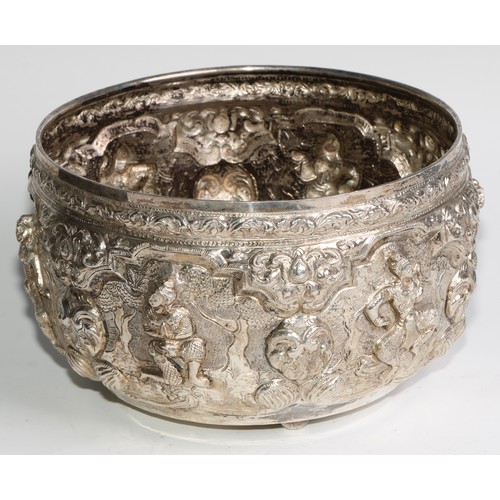 859 - A Burmese silver circular bowl, repousse chased with figures, deities and lotus, 21cm diam, c.1880, ... 