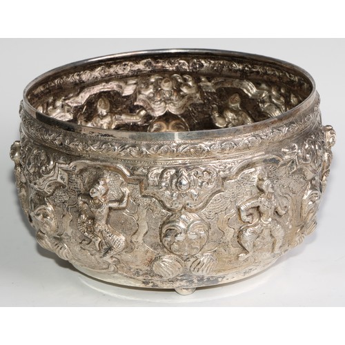 859 - A Burmese silver circular bowl, repousse chased with figures, deities and lotus, 21cm diam, c.1880, ... 