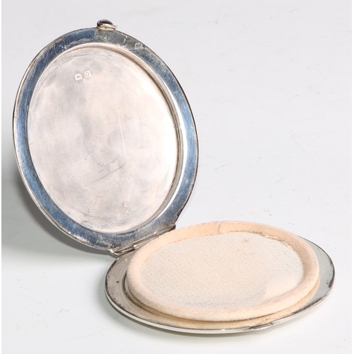 1128 - An Art Deco silver powder compact, hinged cover engraved with a geometric lozenge on an engine turne... 