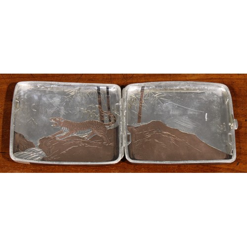 987 - A Japanese silver rounded rectangular cigarette case, decorated in bi-metal with tigers in a rocky l... 