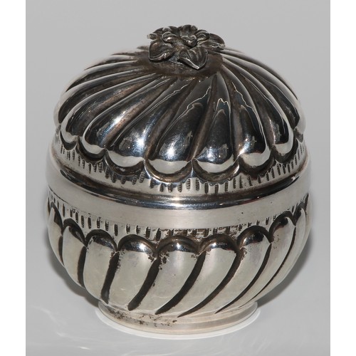 1005 - A Middle Eastern silver fluted circular box and cover, flowerhead finial, gilt interior, 8cm high, m... 