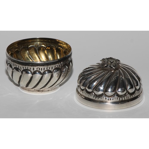 1005 - A Middle Eastern silver fluted circular box and cover, flowerhead finial, gilt interior, 8cm high, m... 