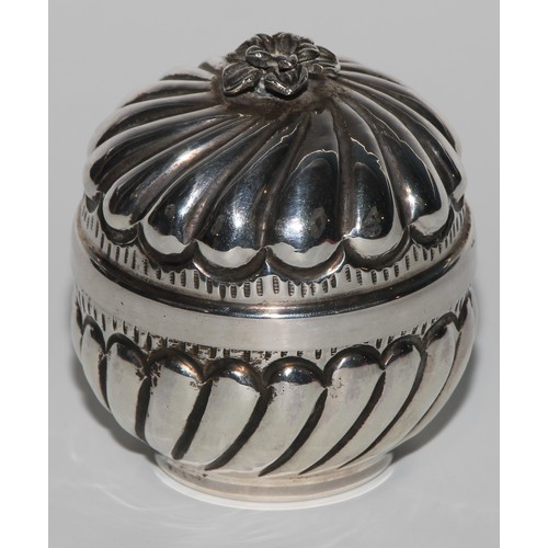 1005 - A Middle Eastern silver fluted circular box and cover, flowerhead finial, gilt interior, 8cm high, m... 