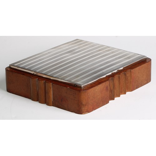 990 - A large Continental Art Deco silver and walnut shaped rectangular cigar box, hinged engine turned co... 