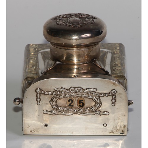 1191 - An unusual Edwardian silver combination inkwell and mechanical perpetual desk calendar, hinged cover... 