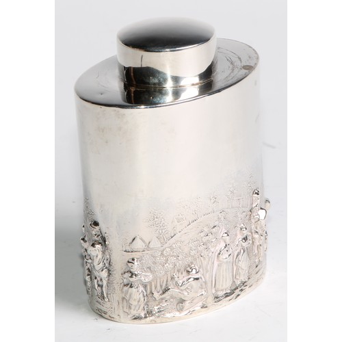 1003 - A late Victorian/Edwardian silver oval tea caddy, chased in the manner of Teniers with figures revel... 