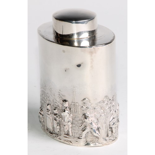 1003 - A late Victorian/Edwardian silver oval tea caddy, chased in the manner of Teniers with figures revel... 