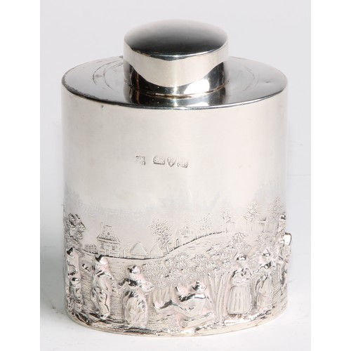 1003 - A late Victorian/Edwardian silver oval tea caddy, chased in the manner of Teniers with figures revel... 