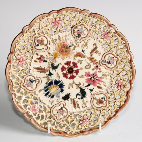 305 - A pair of Zsolnay Pecs shaped circular plates, each decorated in polychrome with stylised flowers, r... 