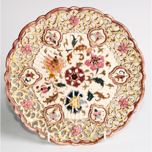 305 - A pair of Zsolnay Pecs shaped circular plates, each decorated in polychrome with stylised flowers, r... 