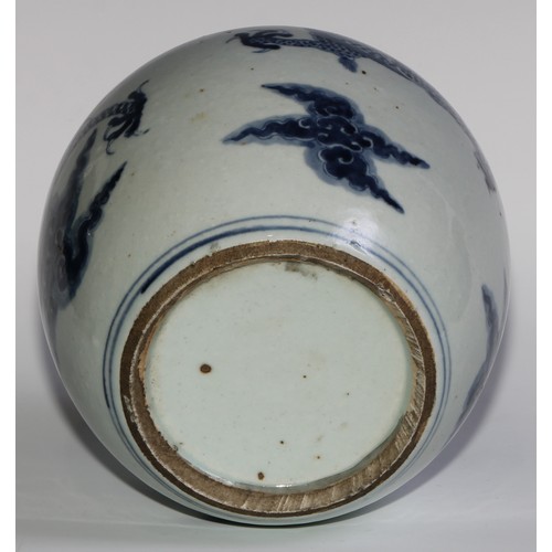 393 - A Chinese ovoid ginger jar, painted in tones of underglaze blue with a dragons chasing flaming pearl... 