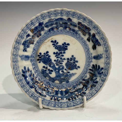 369 - A Chinese fluted shaped circular dish, painted in tones of underglaze blue with flowers and rock wor... 