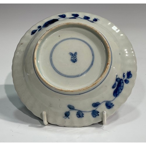 369 - A Chinese fluted shaped circular dish, painted in tones of underglaze blue with flowers and rock wor... 