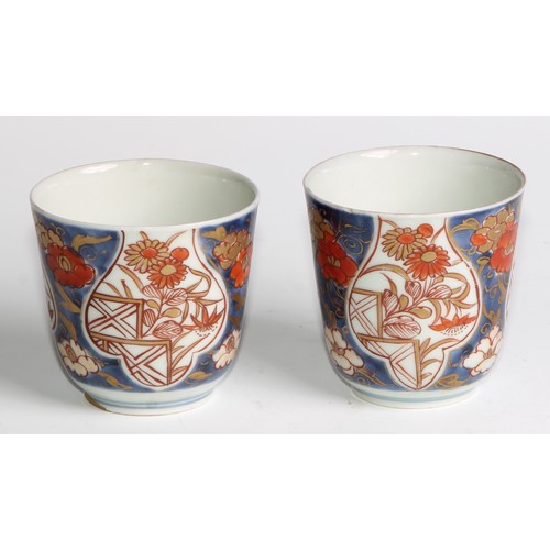 449 - A pair of 18th century Japanese beakers, painted in the Imari palette with flowers and trellis, one ... 