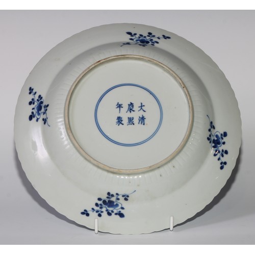 470 - A pair of Chinese shaped circular dishes, painted in tones of underglaze blue with flowers and scrol... 