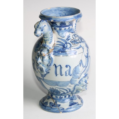 97 - A pair of Delft apothecary drug jars, each inscribed and painted in tones of blue with putti in a la... 