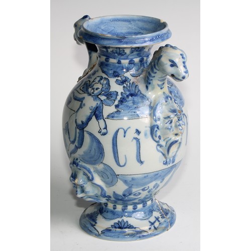 97 - A pair of Delft apothecary drug jars, each inscribed and painted in tones of blue with putti in a la... 