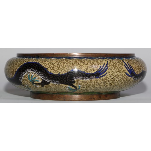 375 - A Chinese cloisonne enamel circular bowl, decorated in polychrome with a ferocious dragon, 17cm diam... 