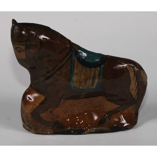 477 - A Persian Islamic pottery model of a horse, glazed in tones of turquoise, brown and yellow, 16cm hig... 