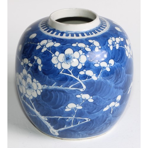 395 - A Chinese ovoid ginger jar, painted in tones of underglaze blue with blossoming prunus on a ground o... 