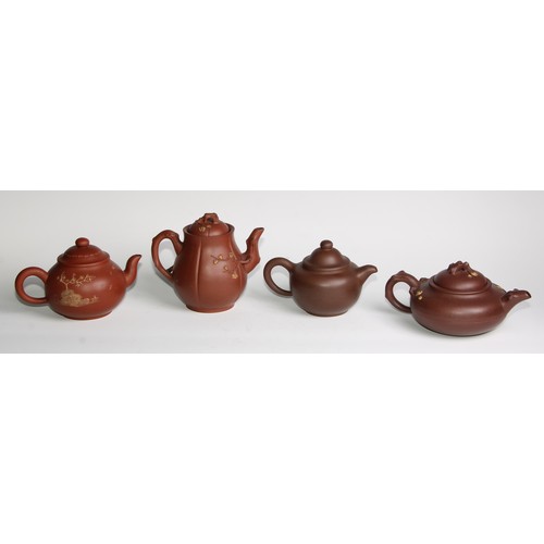 414 - A Chinese Yixing teapot, moulded with blossoming prunus, 15cm high, seal mark; others (4)