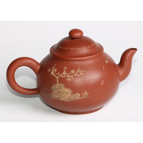 414 - A Chinese Yixing teapot, moulded with blossoming prunus, 15cm high, seal mark; others (4)