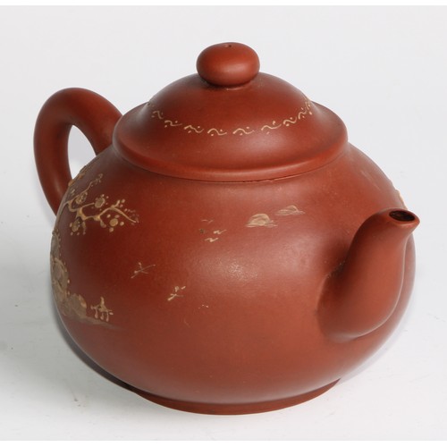 414 - A Chinese Yixing teapot, moulded with blossoming prunus, 15cm high, seal mark; others (4)