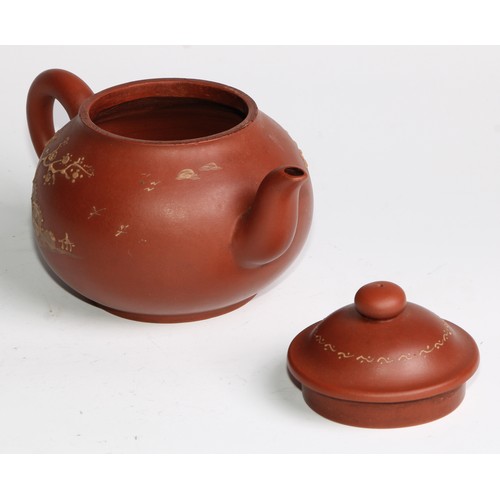 414 - A Chinese Yixing teapot, moulded with blossoming prunus, 15cm high, seal mark; others (4)