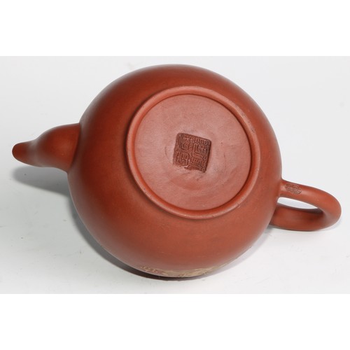 414 - A Chinese Yixing teapot, moulded with blossoming prunus, 15cm high, seal mark; others (4)