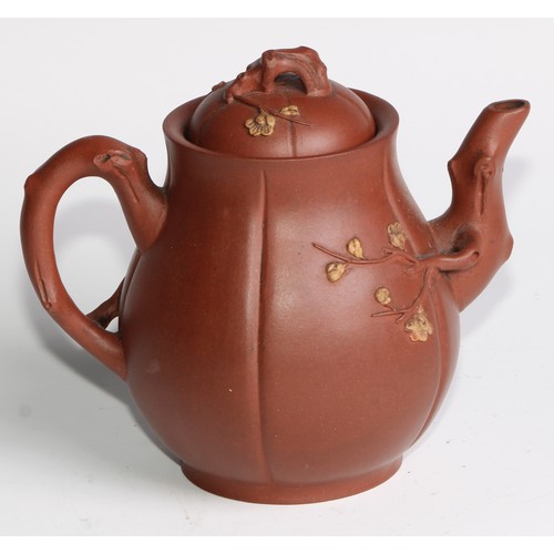 414 - A Chinese Yixing teapot, moulded with blossoming prunus, 15cm high, seal mark; others (4)