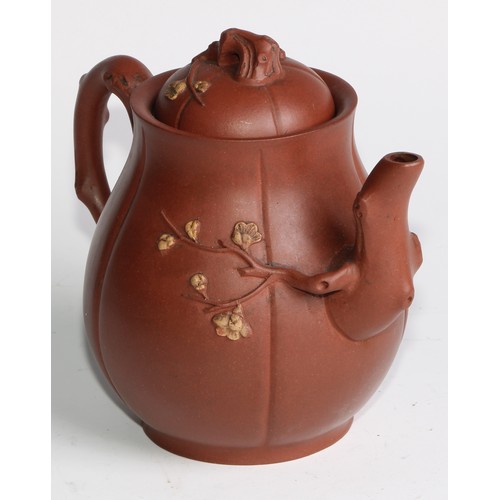 414 - A Chinese Yixing teapot, moulded with blossoming prunus, 15cm high, seal mark; others (4)